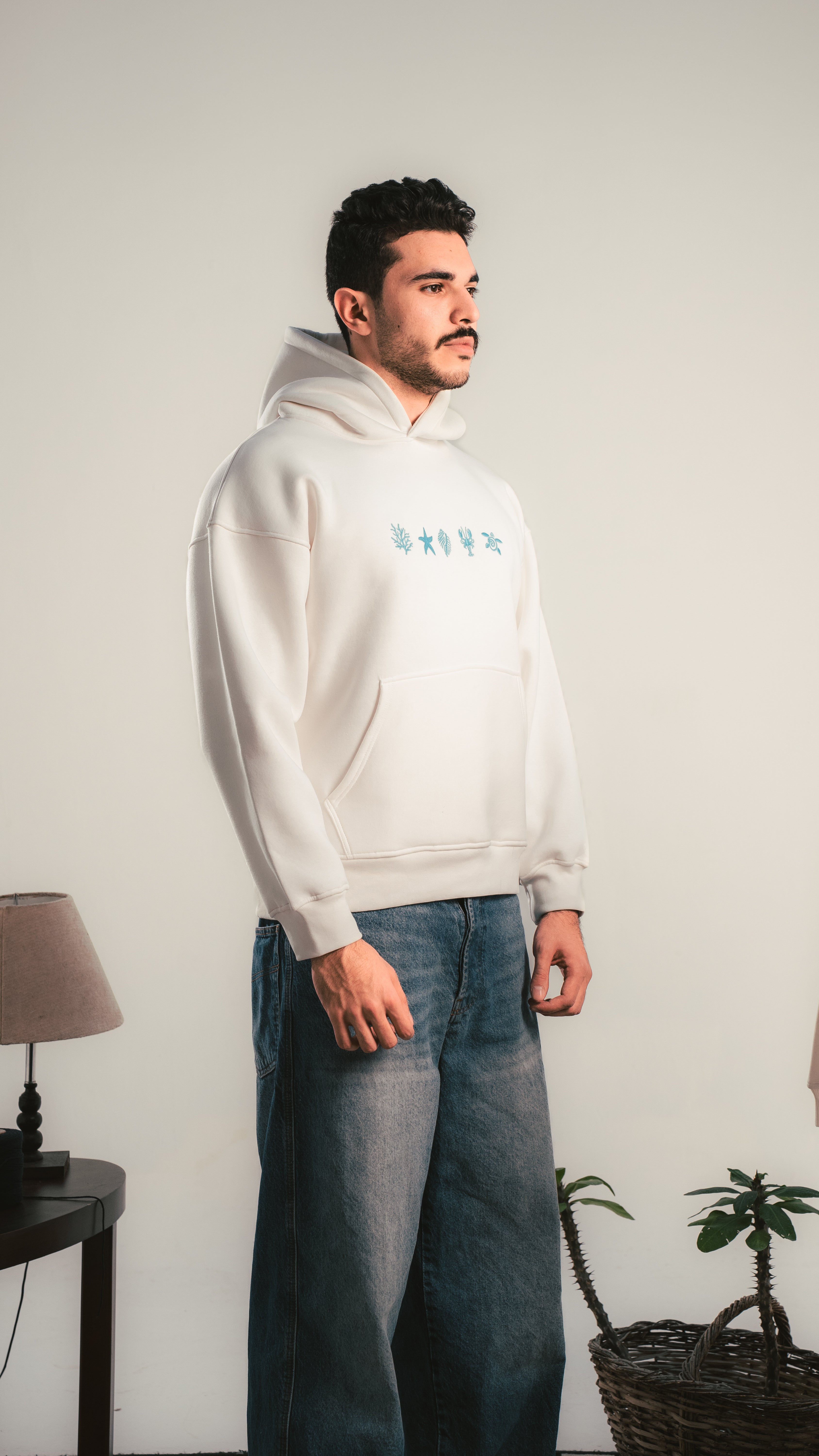 White hoodie with blue chest graphic — side view — Kalium
