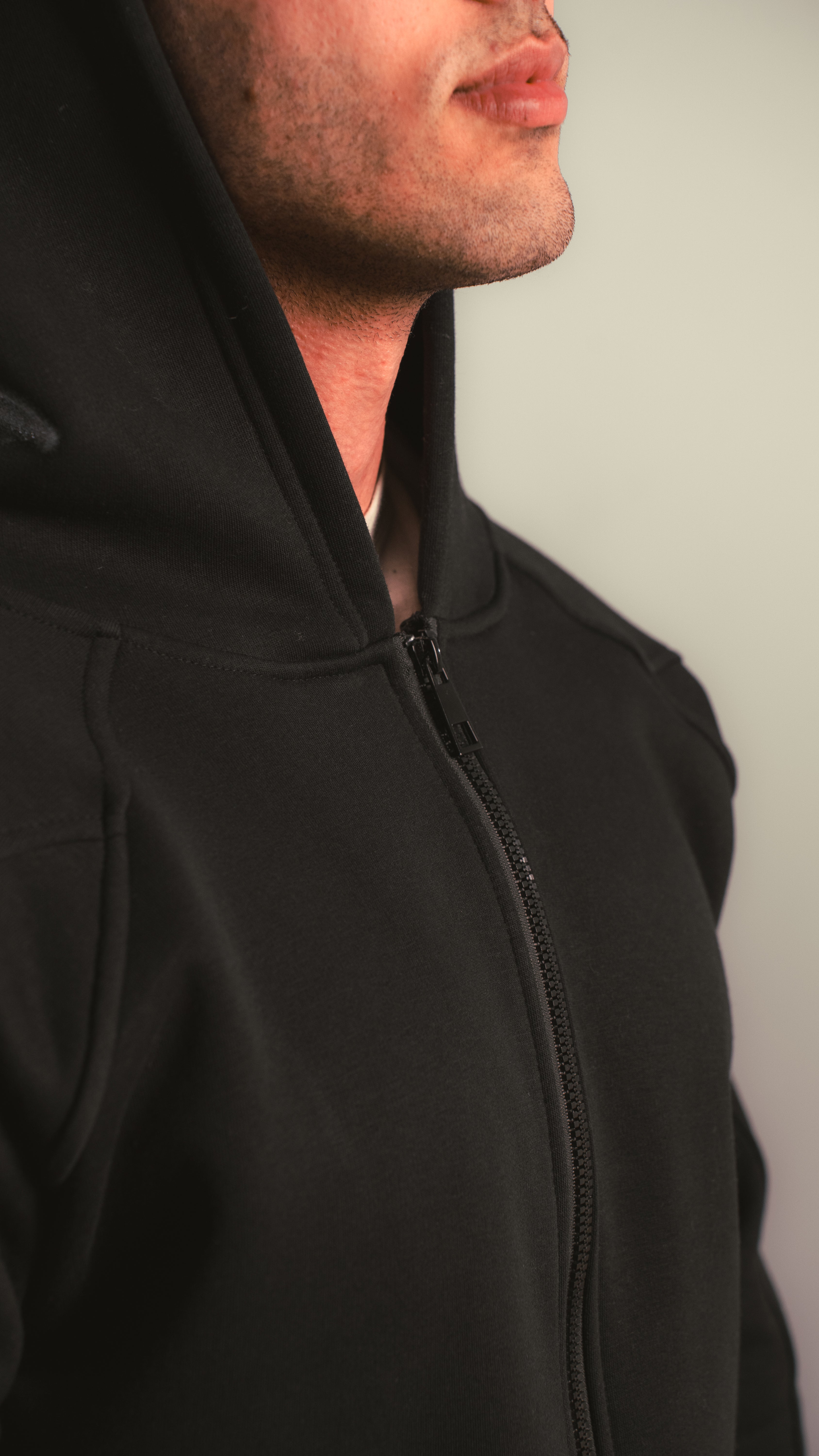 Close-up view of the black zip hoodie zipper — KALIUM