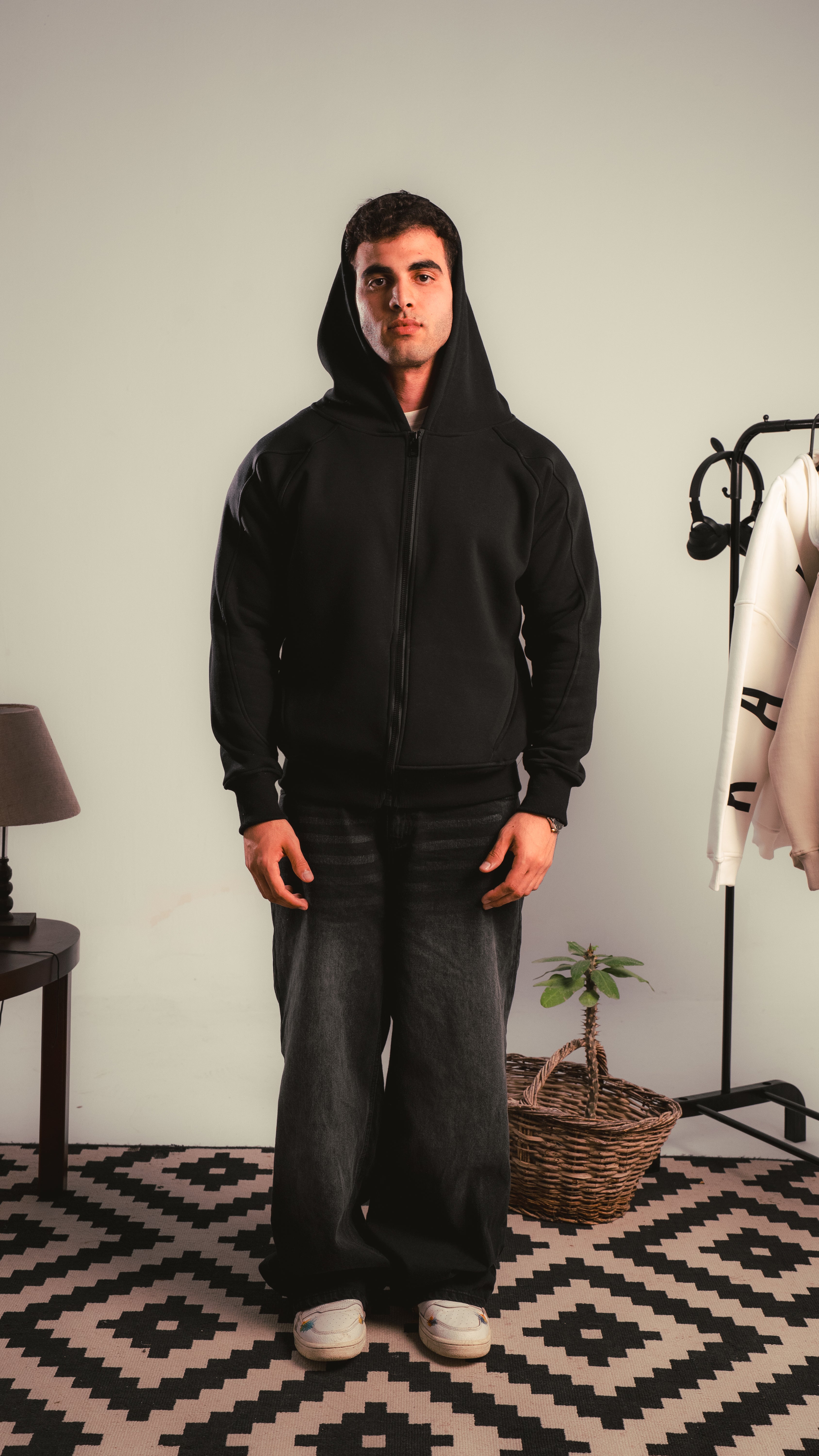 Model wearing a black zip hoodie, full body front view — KALIUM