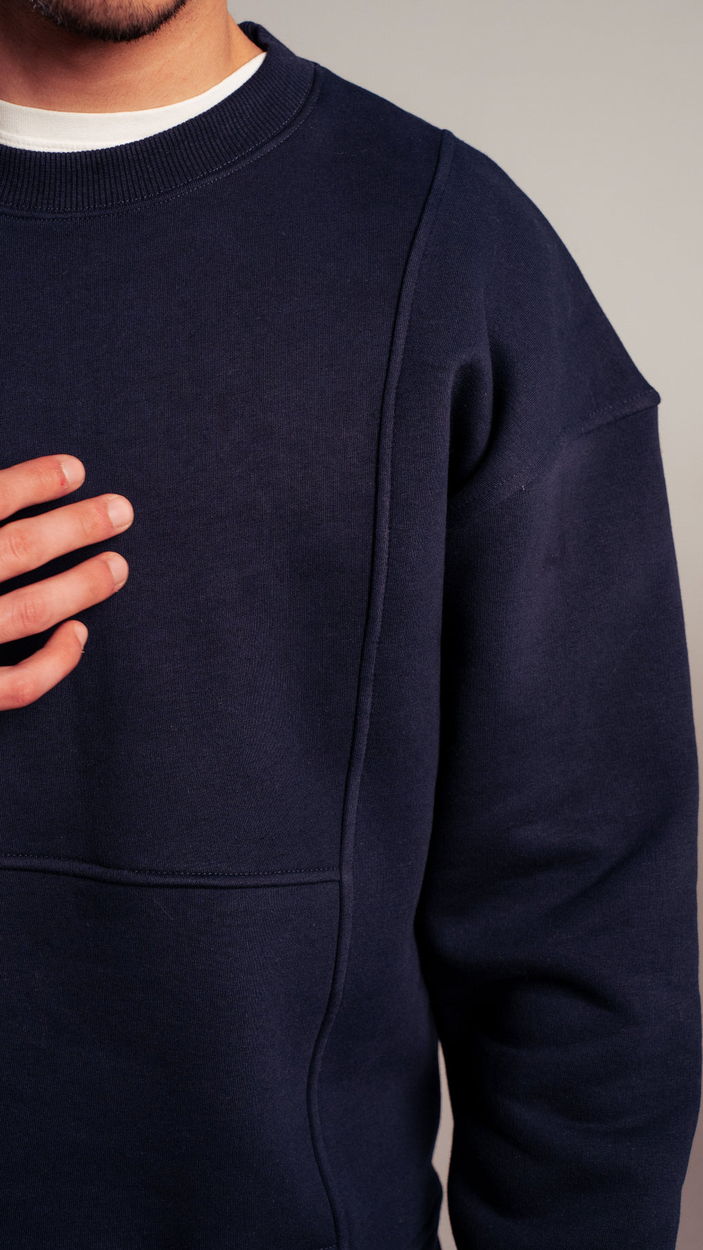 Close-up of navy sweatshirt fabric and stitching details from Kalium.
