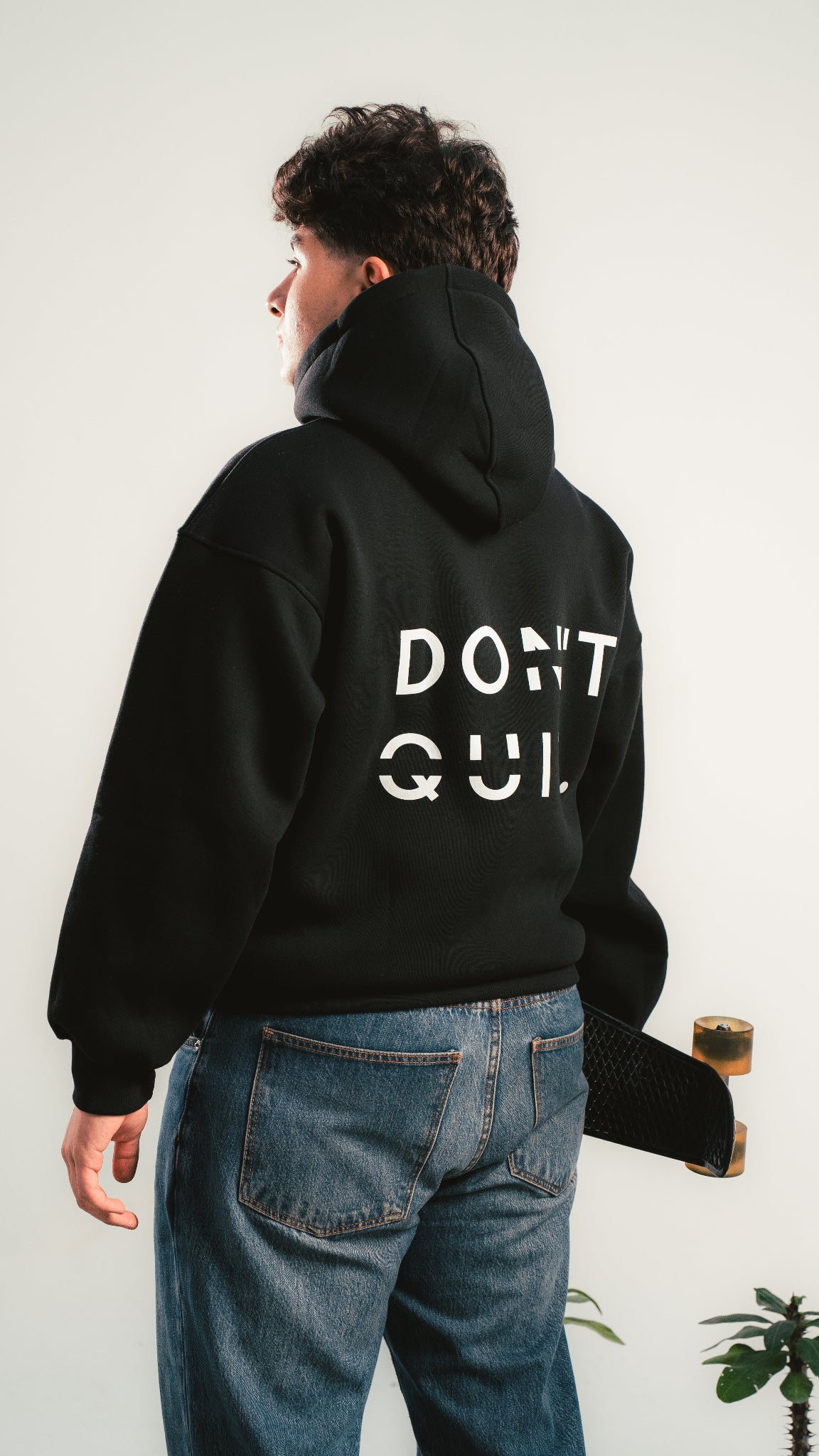 Black DON’T QUIT hoodie – back print – worn by model – Kalium