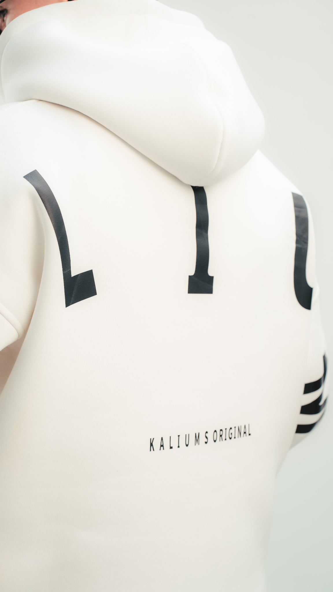 White hoodie with black lettering on a plain background